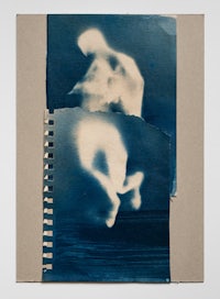 a spiral notebook with a photo of a man and a woman