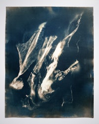 a black and white photo of a plane flying in the sky