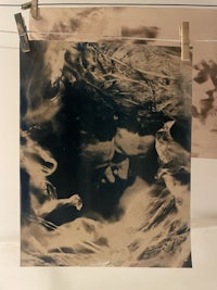 a black and white photo of a woman and a man hanging on a wall